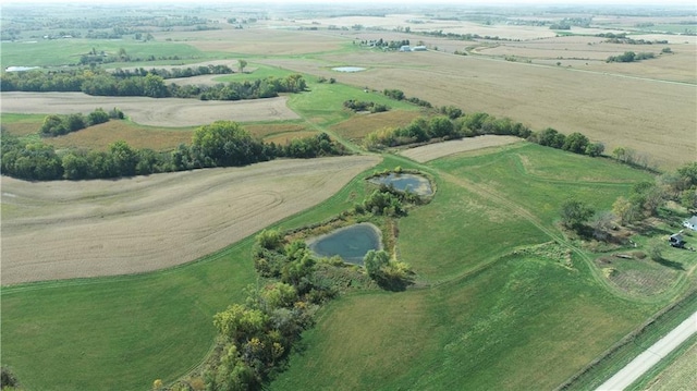 drone / aerial view featuring a rural view and a water view