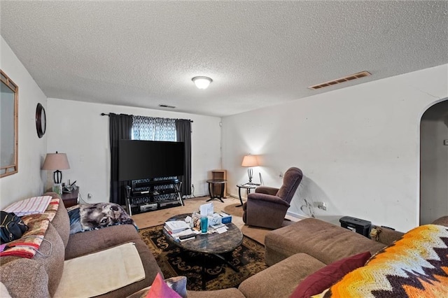 living room with carpet and a textured ceiling