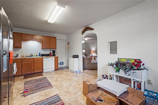 kitchen with dishwasher, a textured ceiling, and sink