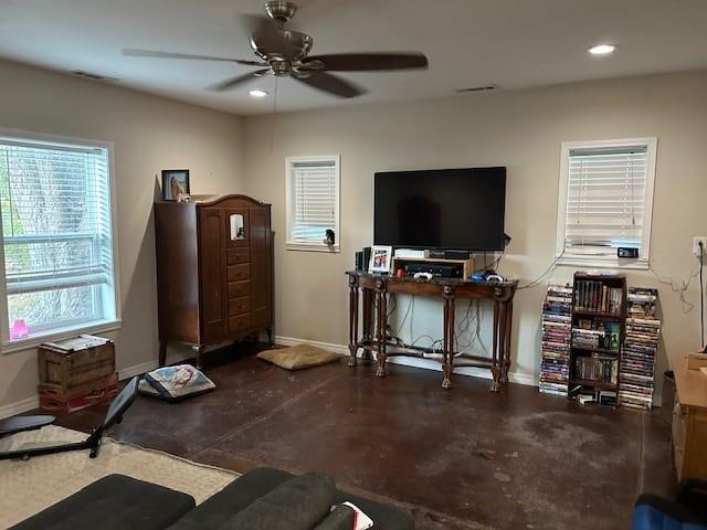 exercise room featuring ceiling fan and concrete floors