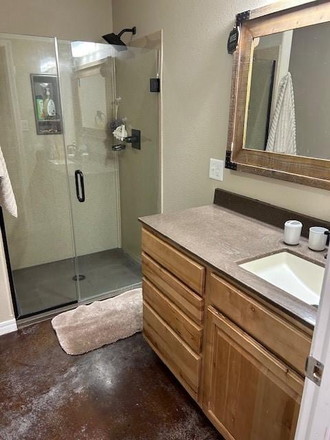 bathroom featuring walk in shower, vanity, and concrete floors