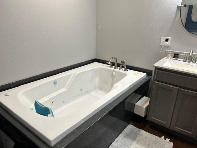 bathroom with vanity and a bathtub