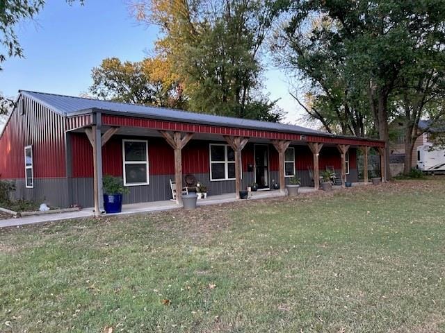 view of front of home with a porch and a front yard