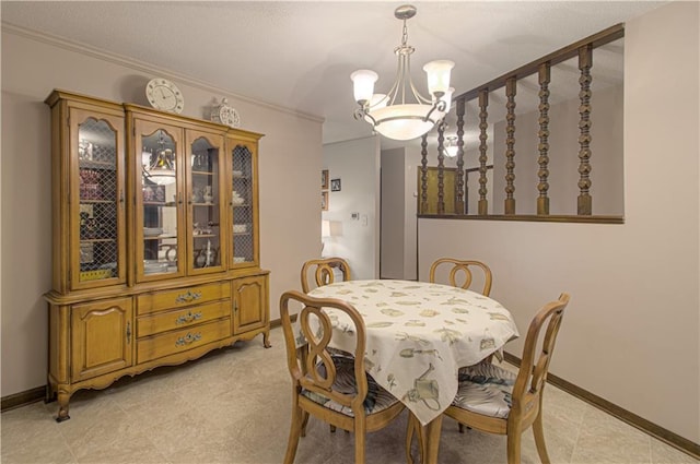 dining room featuring a notable chandelier and ornamental molding