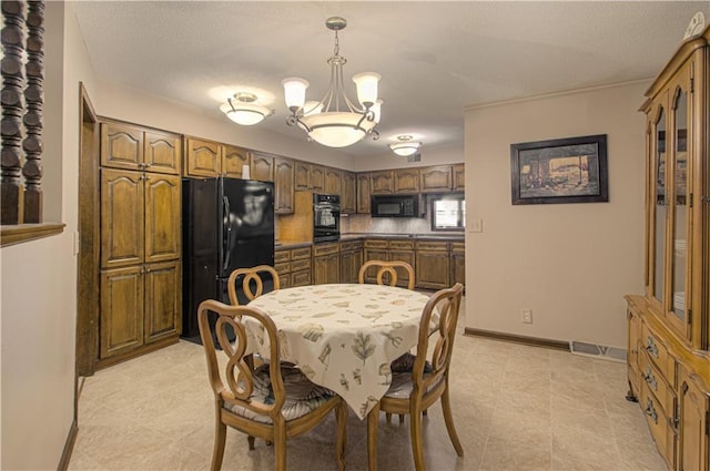 dining area featuring a textured ceiling and an inviting chandelier