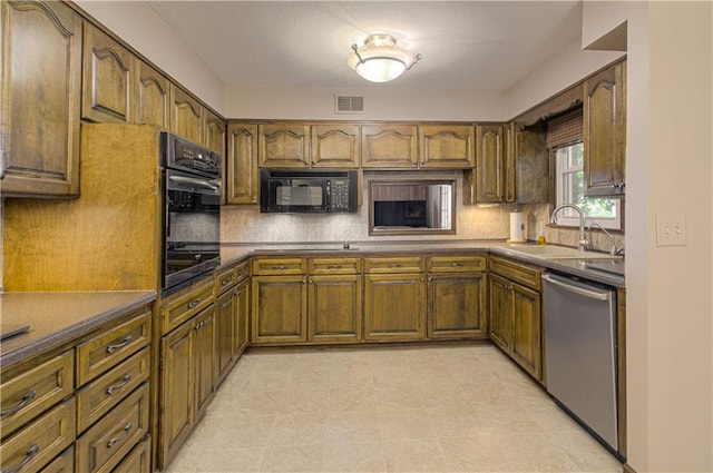 kitchen featuring sink, dishwasher, cooktop, and backsplash