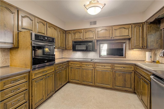 kitchen with sink, decorative backsplash, and stainless steel appliances