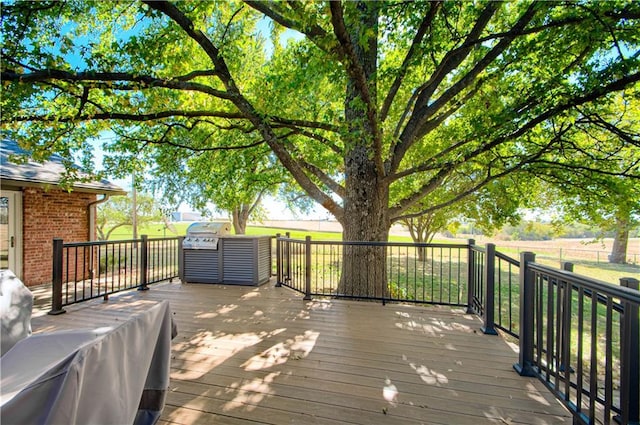 wooden deck with a rural view