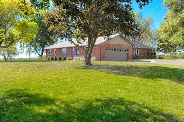 ranch-style house featuring a garage and a front lawn