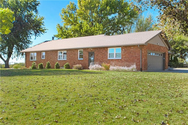 ranch-style home featuring a front yard and a garage