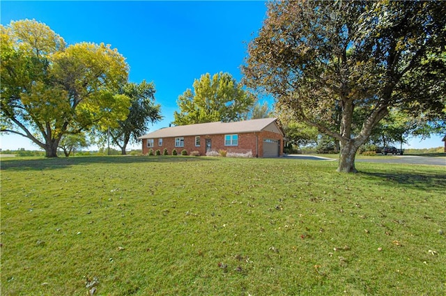 ranch-style home with a front yard and a garage