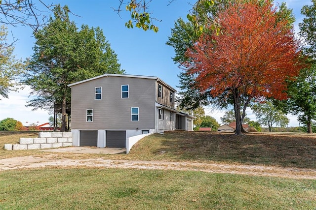 view of side of home with a garage and a lawn