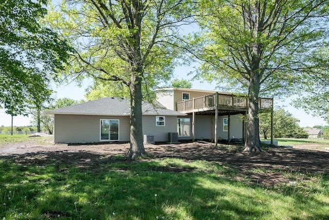 back of house featuring a wooden deck and cooling unit