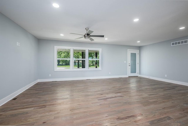 spare room featuring ceiling fan and dark wood-type flooring