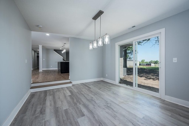 unfurnished dining area featuring hardwood / wood-style floors