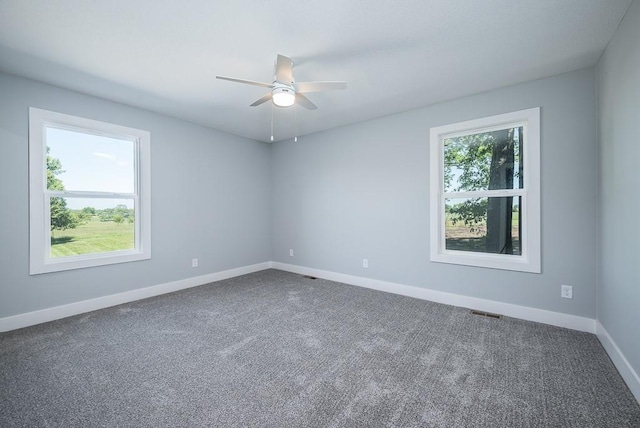 carpeted spare room featuring ceiling fan