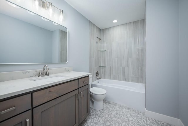 full bathroom featuring tile patterned flooring, tiled shower / bath, vanity, and toilet