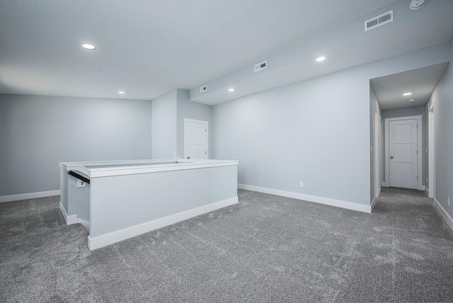 empty room featuring dark colored carpet