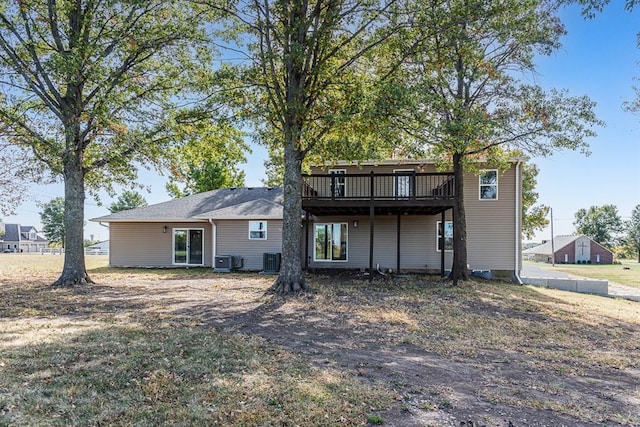 back of property featuring cooling unit and a wooden deck