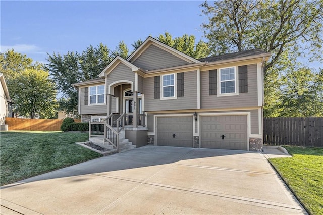 bi-level home with a front lawn and a garage