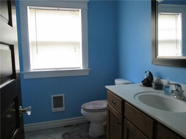 bathroom featuring vanity, toilet, and tile patterned flooring