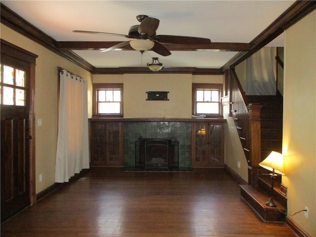 unfurnished living room with stairway, a fireplace, wood finished floors, and baseboards