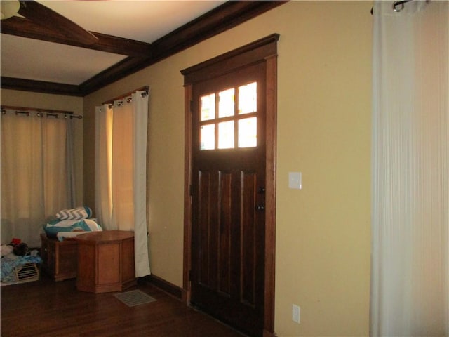 foyer entrance featuring dark wood finished floors and baseboards