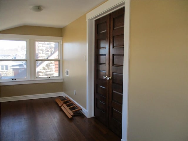 foyer entrance with dark wood-style floors, visible vents, and baseboards