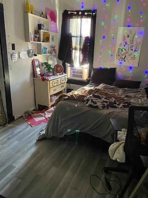 bedroom with cooling unit and hardwood / wood-style floors