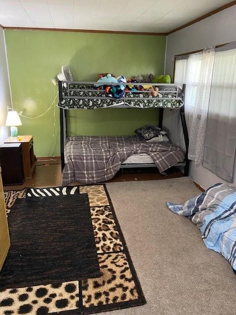 carpeted bedroom featuring crown molding