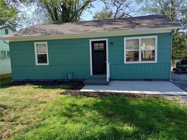 view of front facade featuring a front yard, crawl space, and roof with shingles