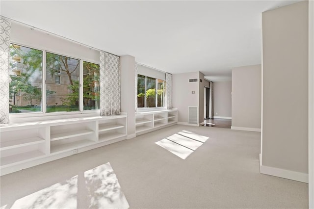 empty room with light carpet, baseboards, and visible vents