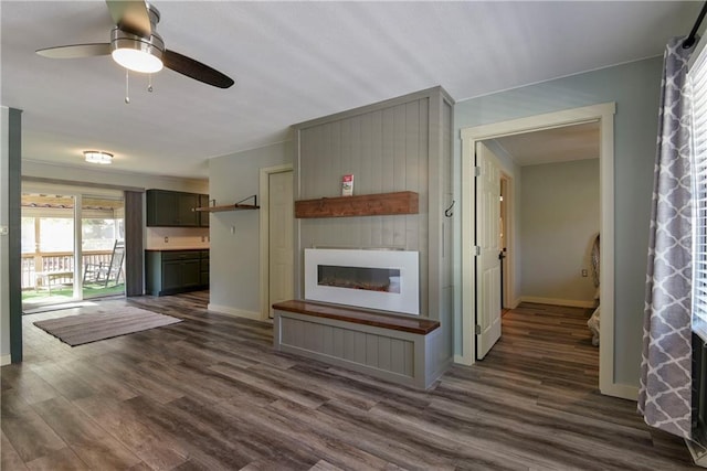 unfurnished living room with ceiling fan and dark hardwood / wood-style floors