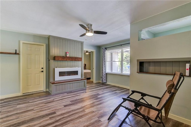 living room featuring light wood-type flooring and ceiling fan