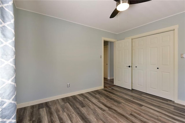 unfurnished bedroom with a closet, dark hardwood / wood-style flooring, and ceiling fan