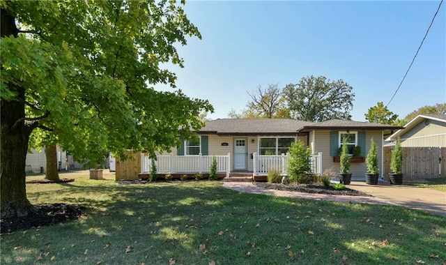 ranch-style home with a porch and a front lawn