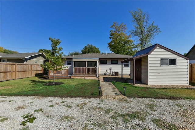 back of property with a lawn and central AC unit