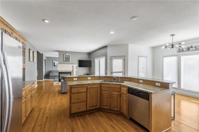 kitchen featuring plenty of natural light, stainless steel appliances, and light hardwood / wood-style flooring