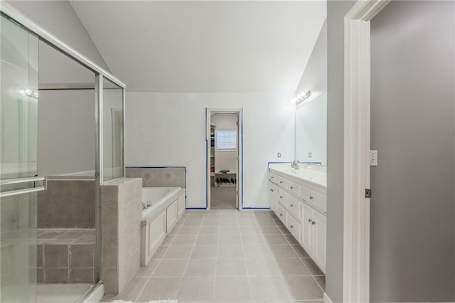 bathroom featuring tile patterned flooring, vanity, lofted ceiling, and plus walk in shower