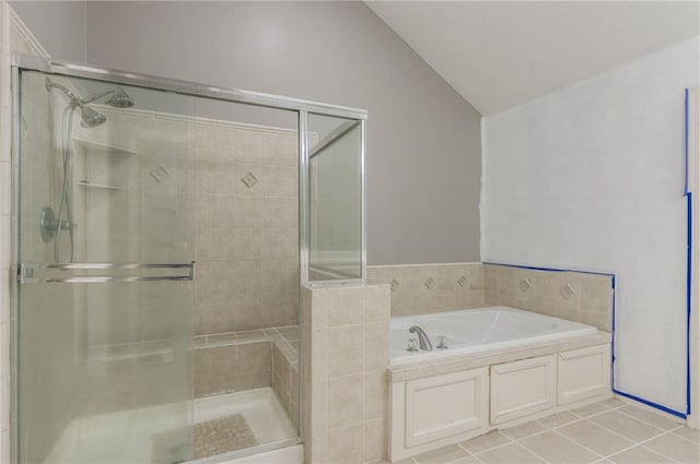 bathroom with plus walk in shower, vaulted ceiling, and tile patterned flooring