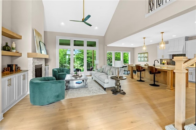 7016 N Polk Ave, Kansas City, MO 64151 - living area featuring a fireplace, a ceiling fan, high vaulted ceiling, light wood-style flooring, and recessed lighting