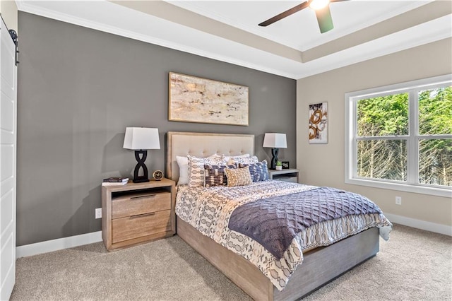 7016 N Polk Ave, Kansas City, MO 64151 - bedroom featuring light carpet, ornamental molding, baseboards, a raised ceiling, and a barn door