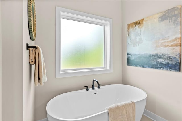 7016 N Polk Ave, Kansas City, MO 64151 - bathroom with a freestanding bath and baseboards