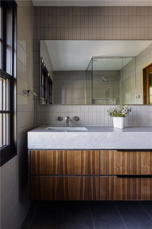 bathroom featuring vanity, tile walls, and tile patterned flooring