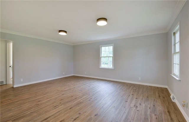 unfurnished room with crown molding and light wood-type flooring