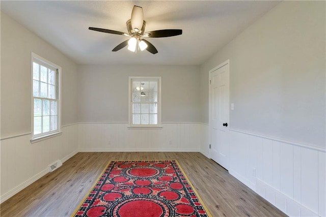 unfurnished room featuring light hardwood / wood-style floors and ceiling fan