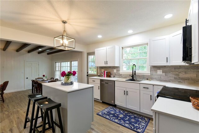 kitchen featuring a kitchen island, black appliances, sink, and white cabinets