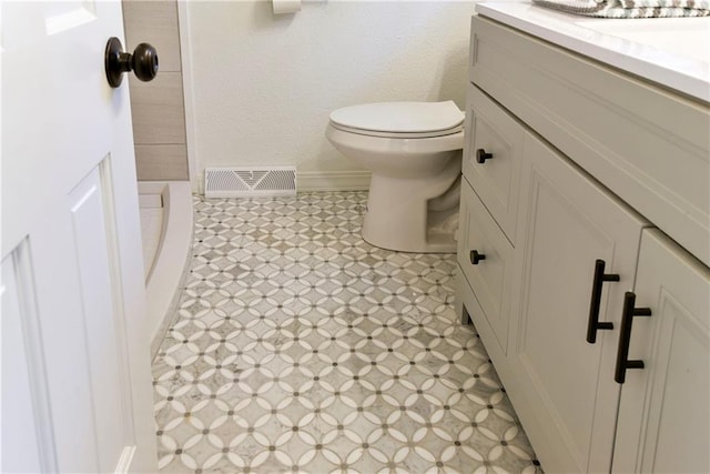 bathroom featuring toilet and vanity