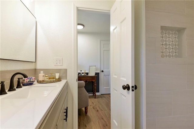 bathroom with hardwood / wood-style flooring and vanity