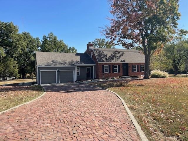 ranch-style home with a garage and a front yard